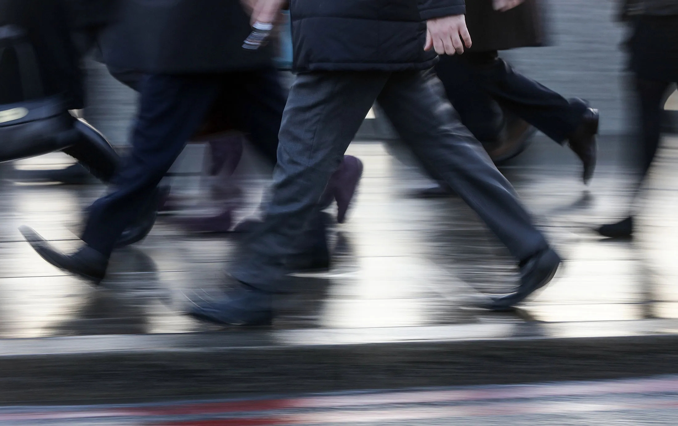 Pedestrians walk across London Bridge towards the City of London financial district, U.K., on Monday, Jan. 4, 2016. U.K. stocks got no respite in the new year, after their worst annual drop since 2011, amid investor concern over a slowdown in China, the biggest consumer of commodities.
