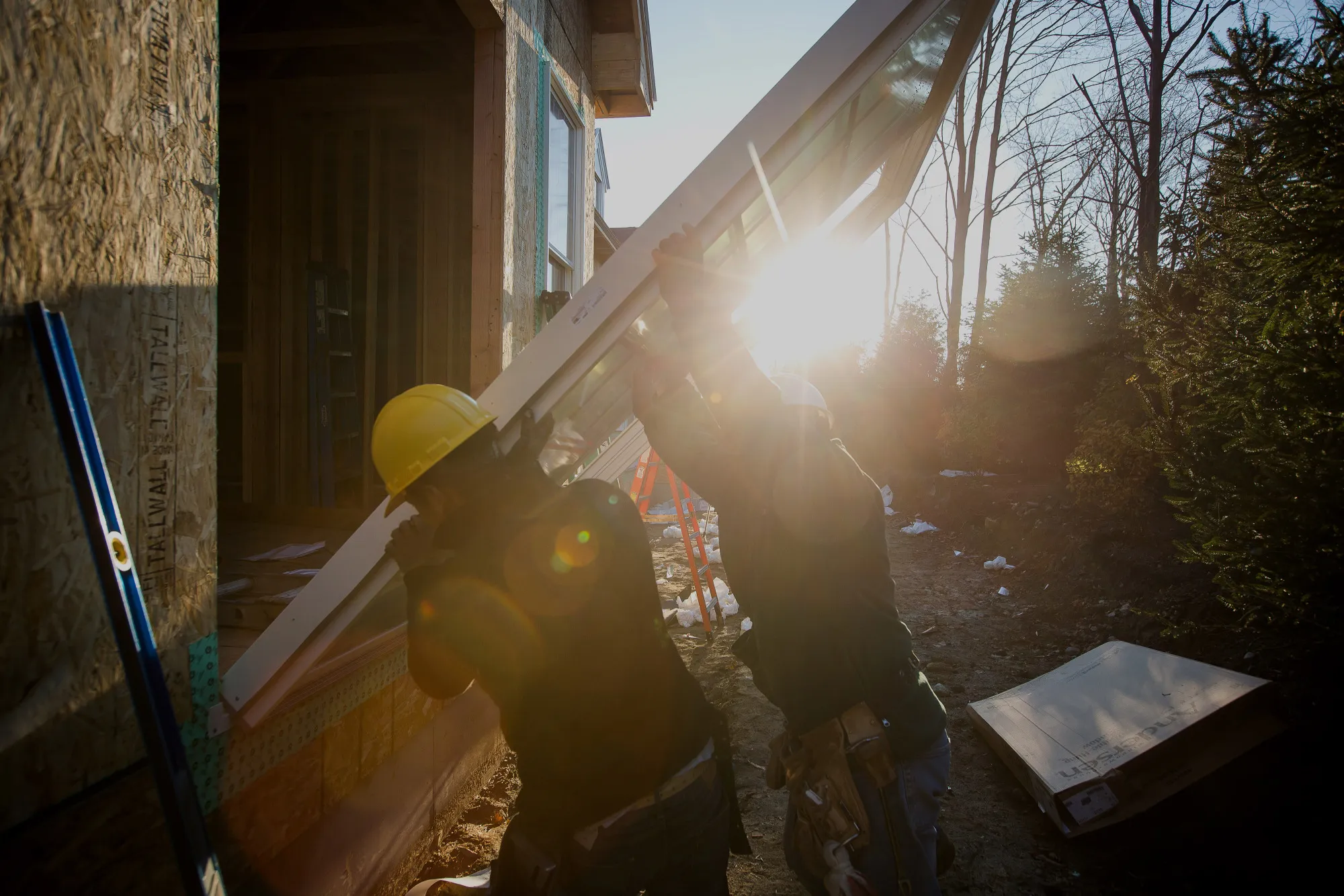 Contractors install a sliding door for a home under construction.