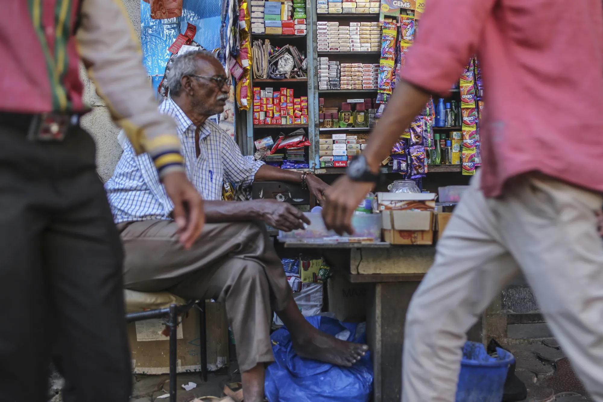 A cigarette vendor waits for customers at a stall in Mumbai.