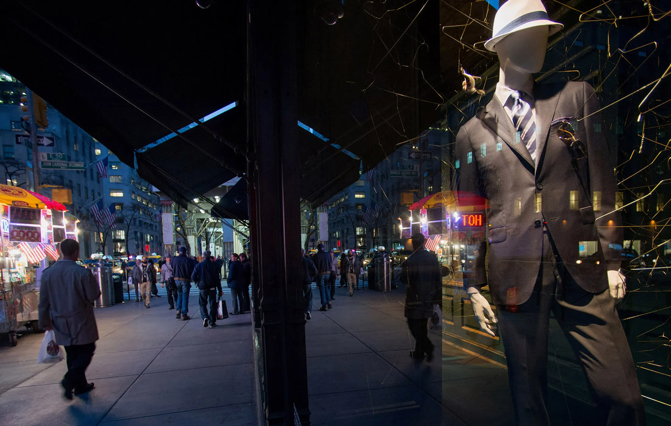 A mannequin stands on display in the window of a store on 5th Avenue in New York.
