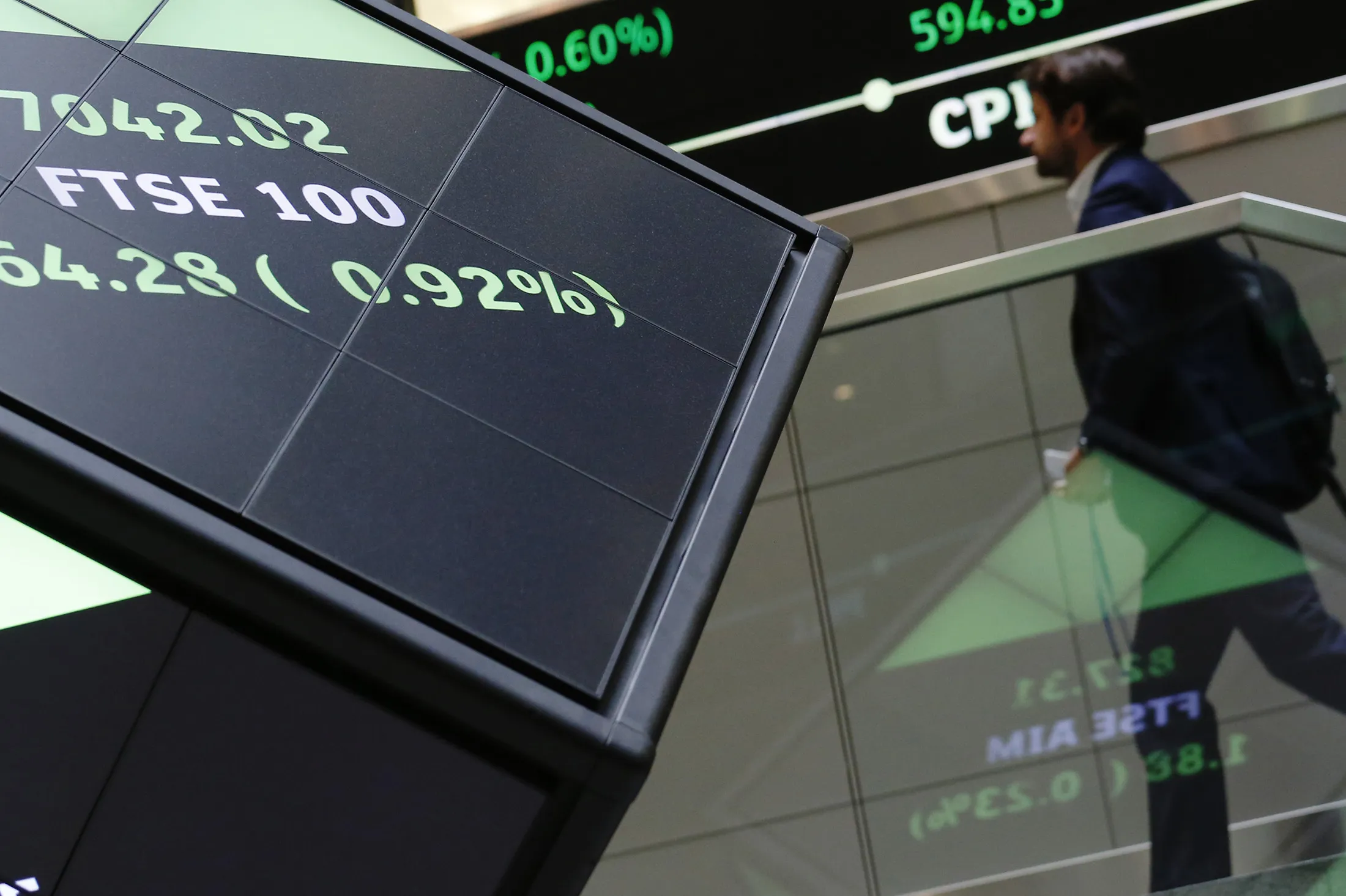 The share price of the FTSE 100 index is displayed on an illuminated rotating cube in the atrium of the London Stock Exchange Group Plc's offices in London.
