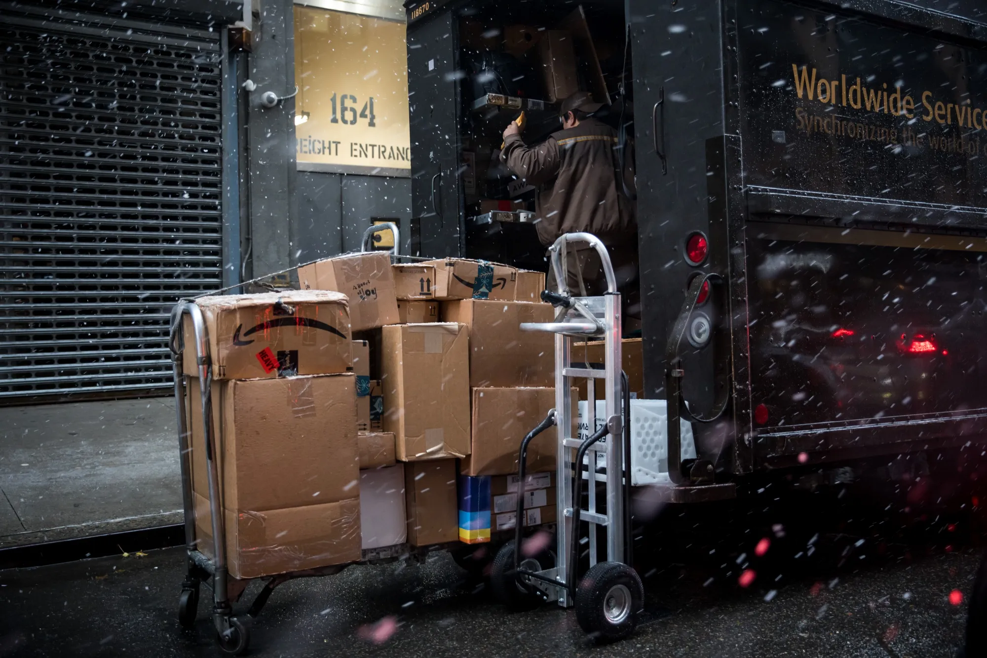 A driver&nbsp;unloads packages from a delivery truck&nbsp;in New York.