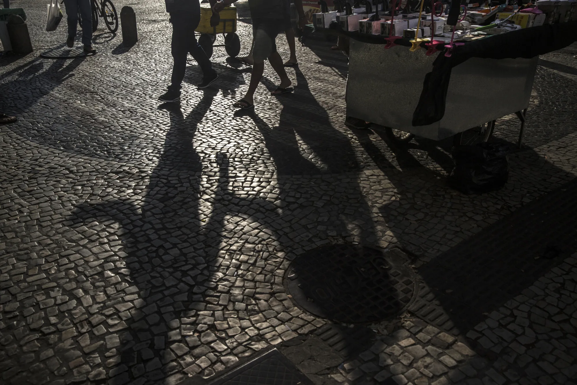 Pedestrians pass in front of street vendors in downtown Rio de Janeiro, Brazil, on Tuesday, Sept. 26, 2017.&nbsp;