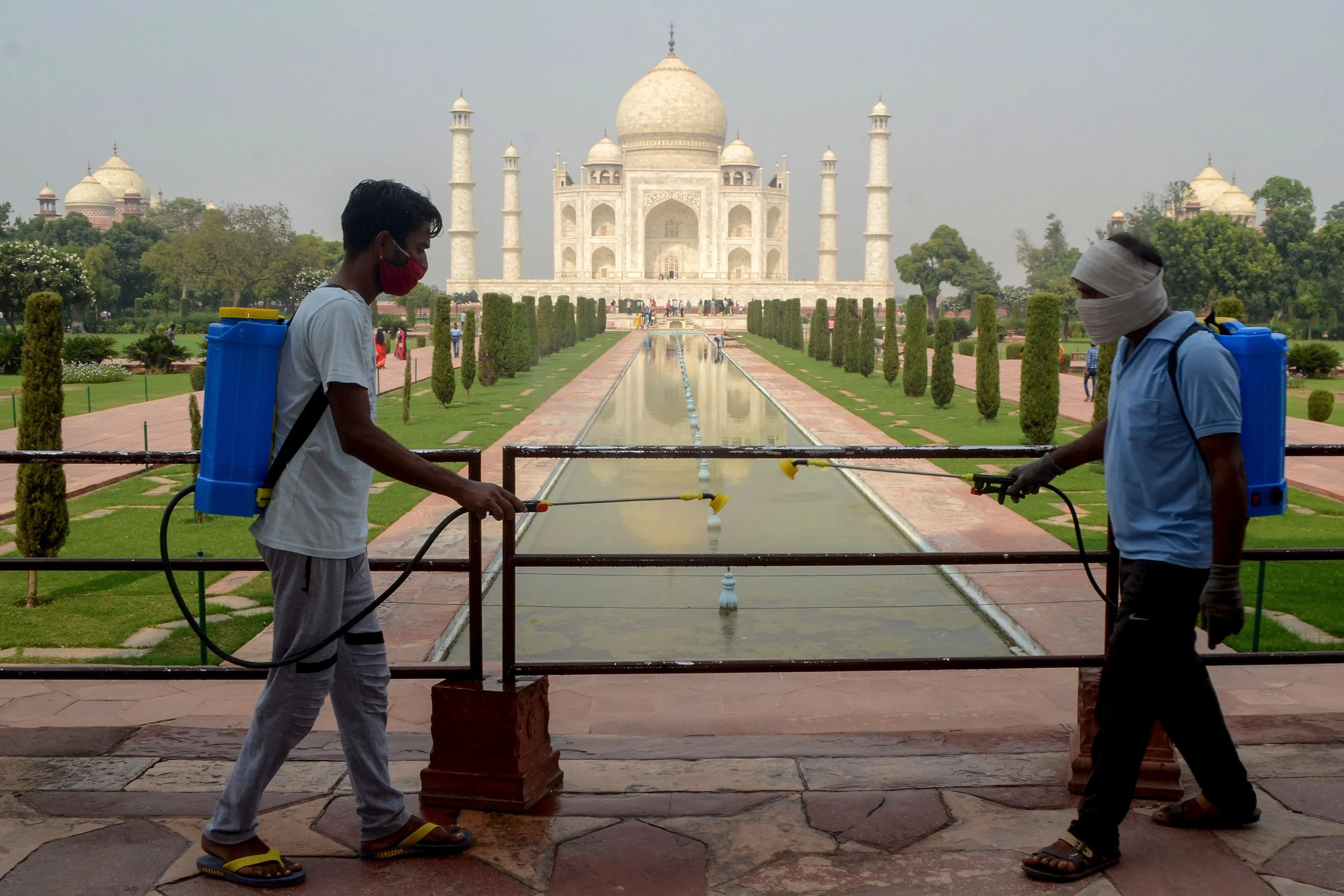 Workers sanitize the premises of the Taj Mahal.