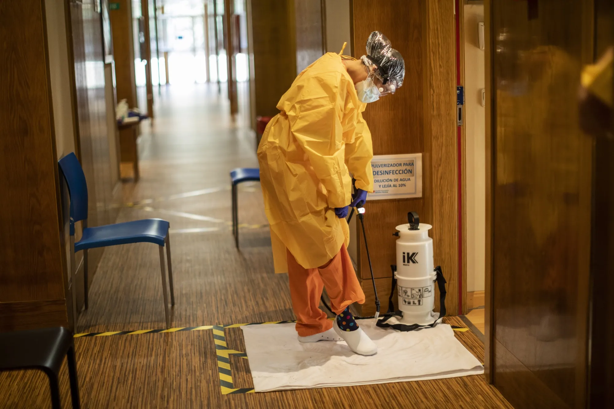 A health worker disinfects her shoes at a hotel housing Covid-19 patients near Madrid.
