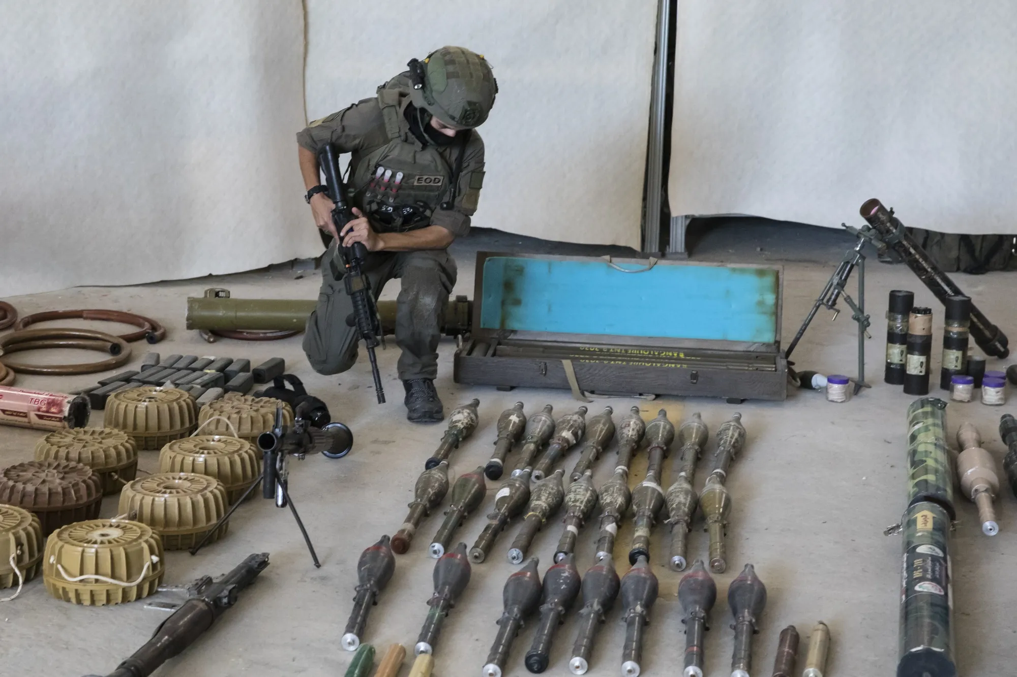 An Israeli soldier displays military equipment used by militants during the Oct. 7 attack against Israel.&nbsp;