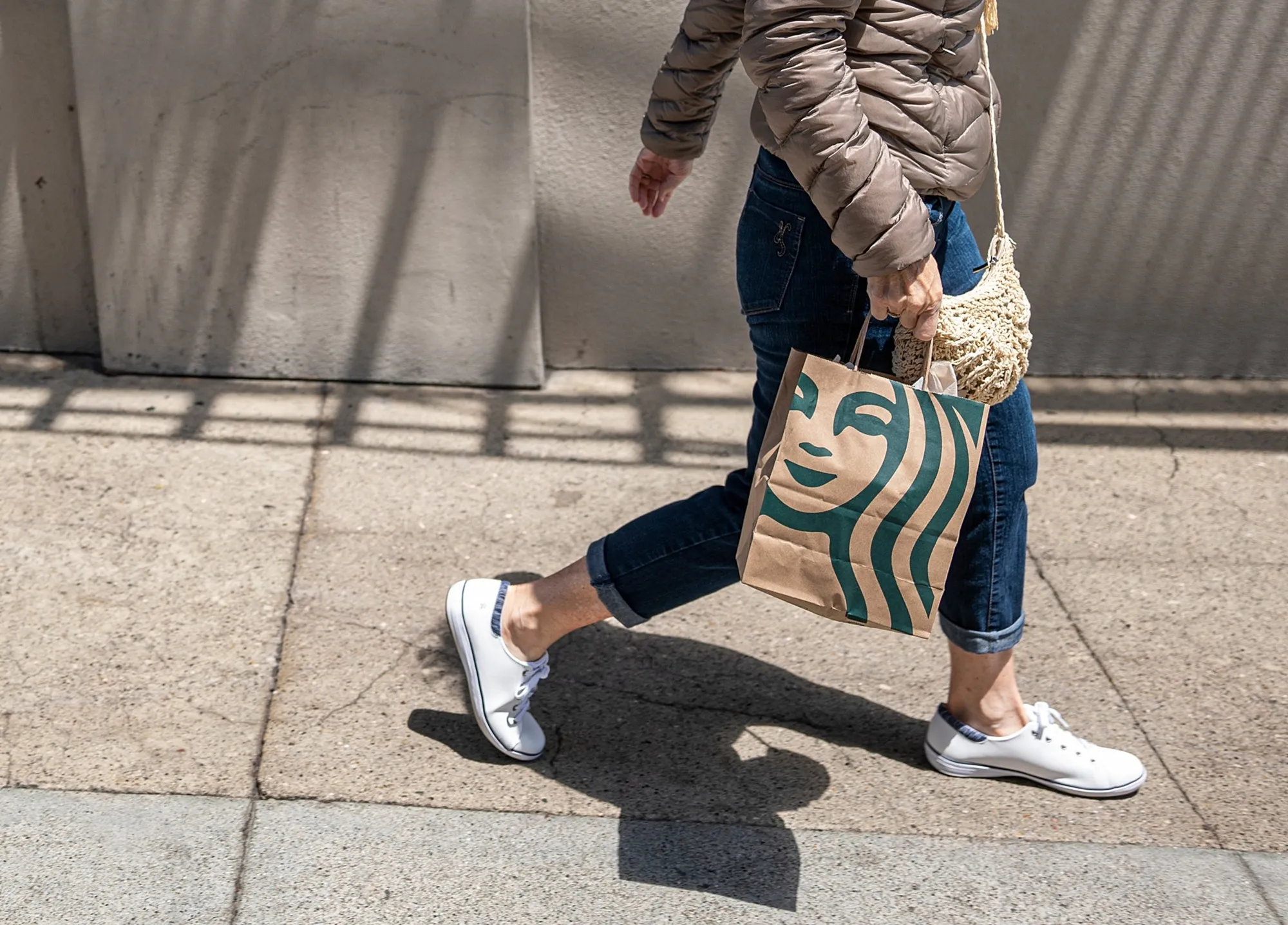 A person carries a Starbucks&nbsp;shopping bag in San Francisco.