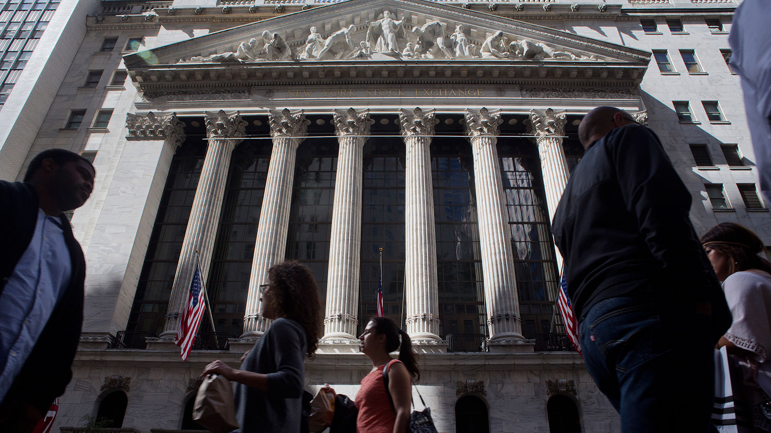 Pedestrians pass by the New York Stock Exchange in New York on Sept. 26, 2014.

