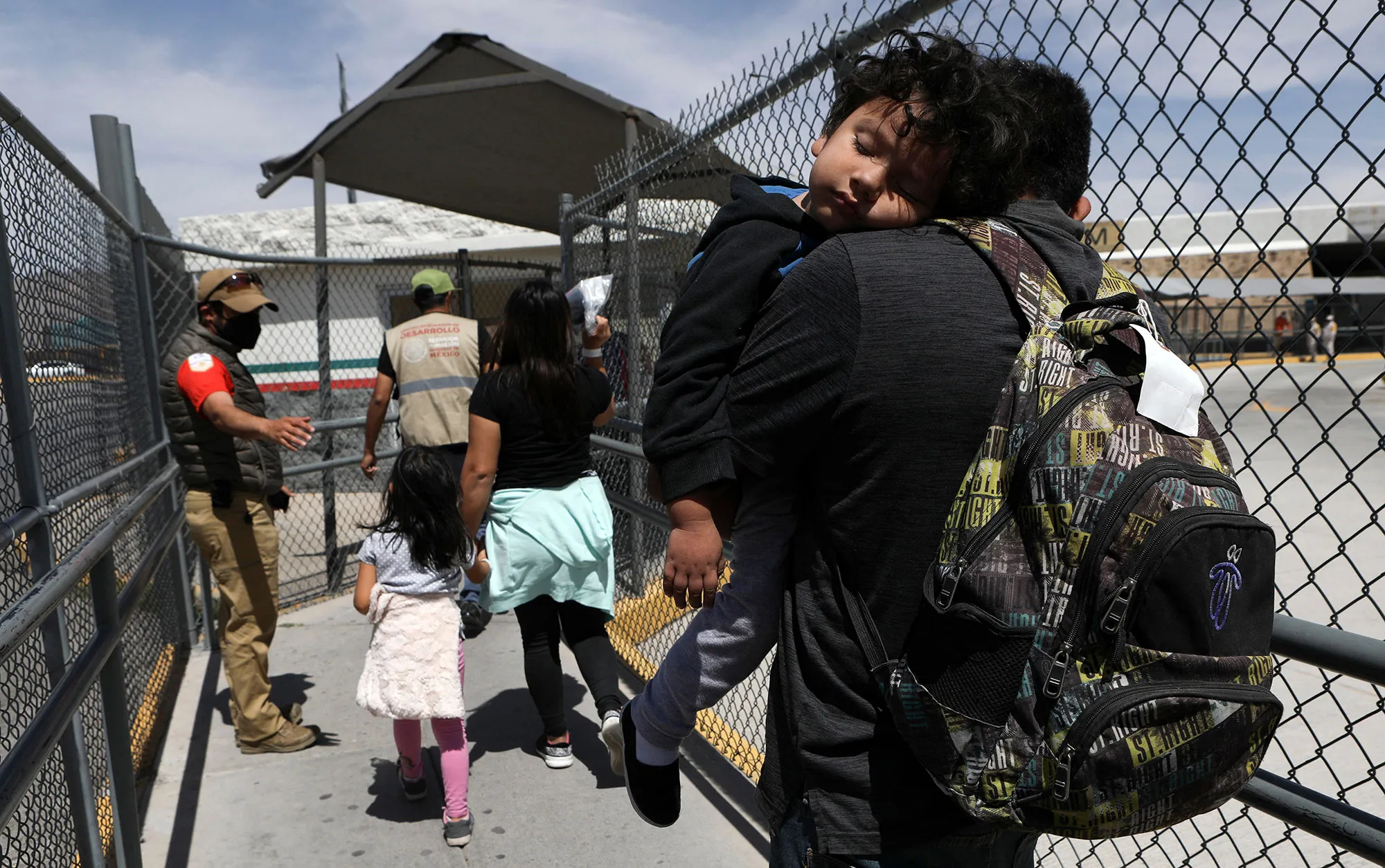 Migrants walk along the Stanton international bridge from El Paso, Texas to Ciudad Juarez, Chihuahua state, Mexico, as they are expelled from the US, on March 29.