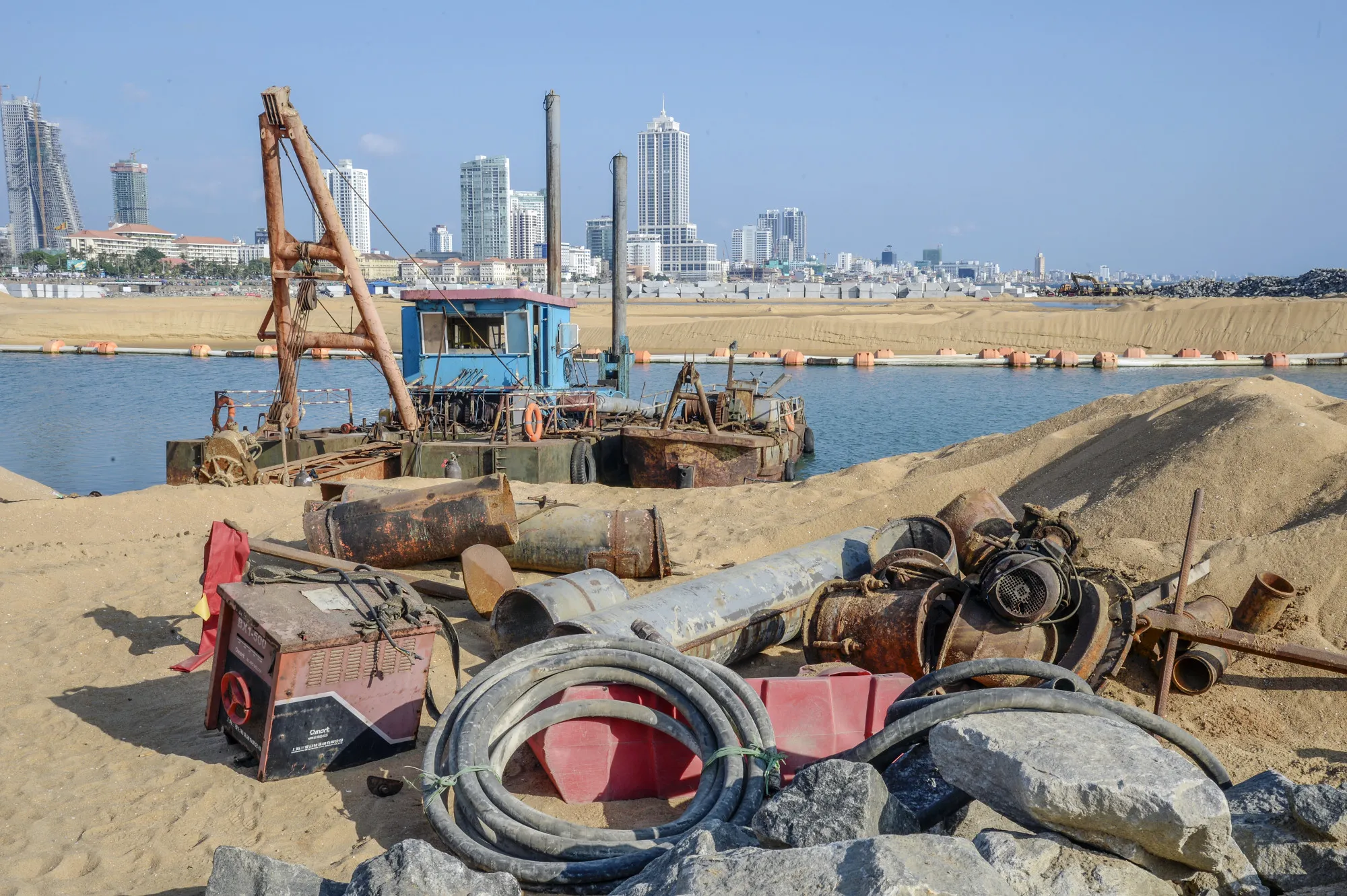 Boats sit docked as equipment sits at the&nbsp;site of Colombo Port City&nbsp;in Colombo, Sri Lanka.