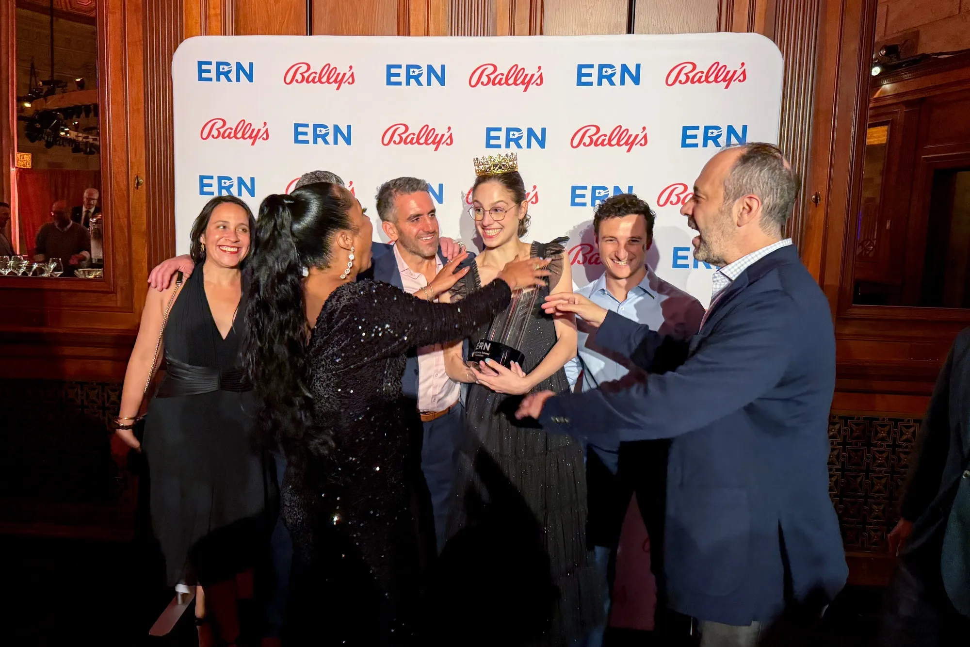 Sasha Cohen, center, after winning the Education Reform Now poker tournament at Gotham Hall in New York.