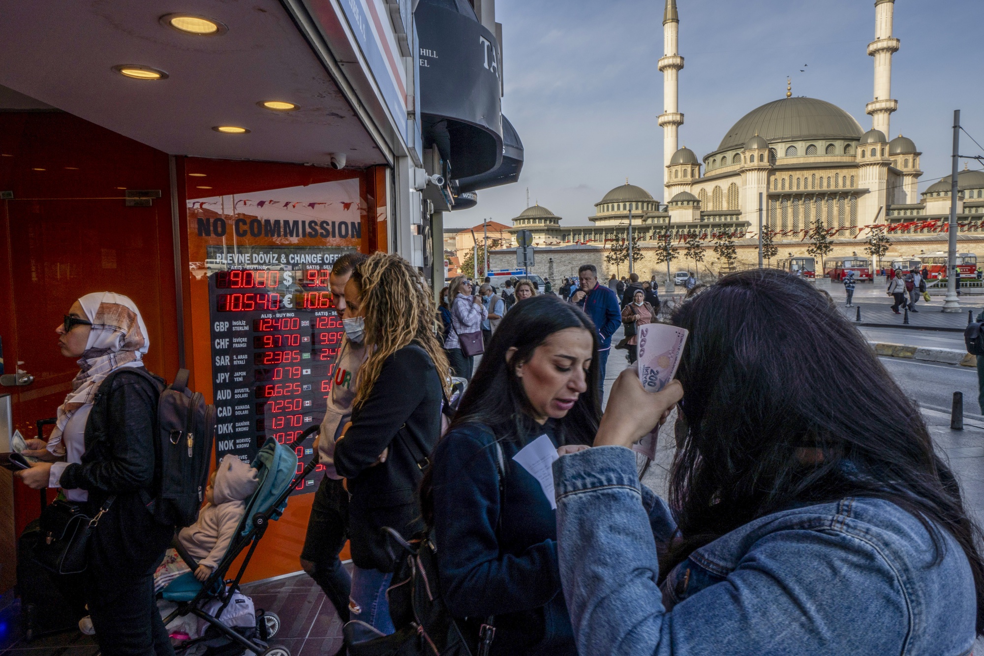 Customers at a currency exchange bureau on Taksim square in Istanbul, Turkey.