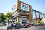 Tuk Tuk drivers wait for customers outside a Tesco-Lotus supermarket in Bangkok
