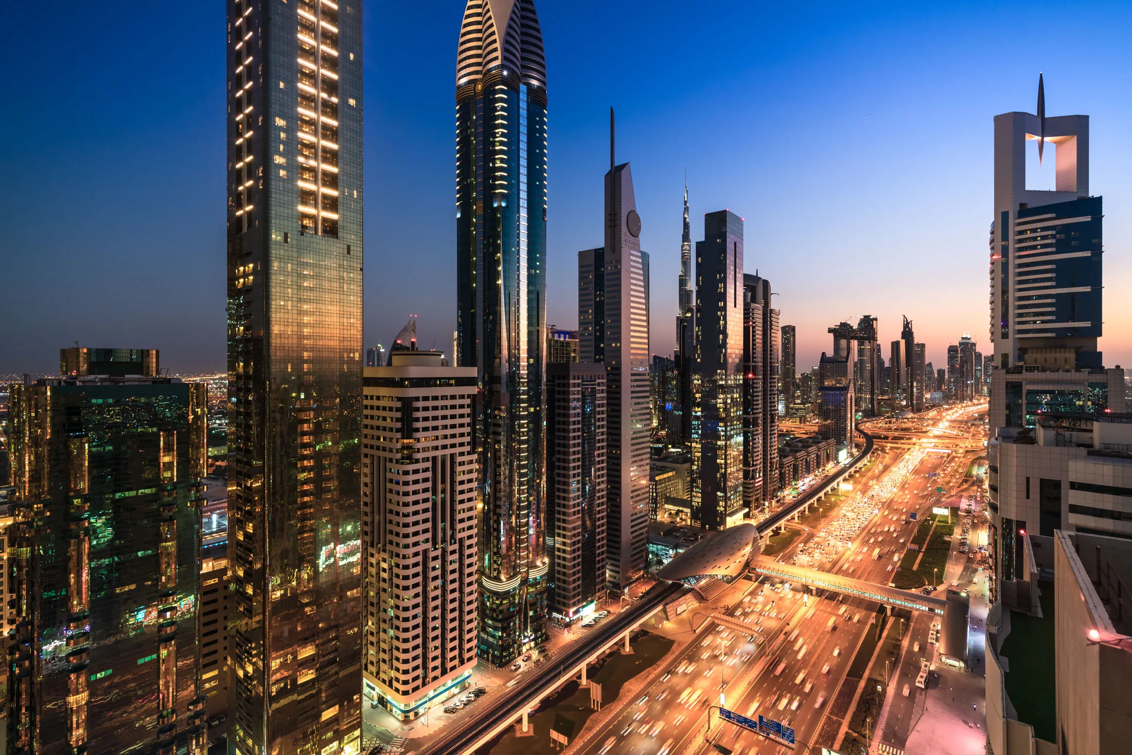 High angle views of urban skyline and skyscrapers at sunset in Dubai UAE.