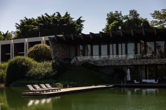 Lounge chairs on a lake-side deck at the 5-star Fasano Hotel Boa Vista.
