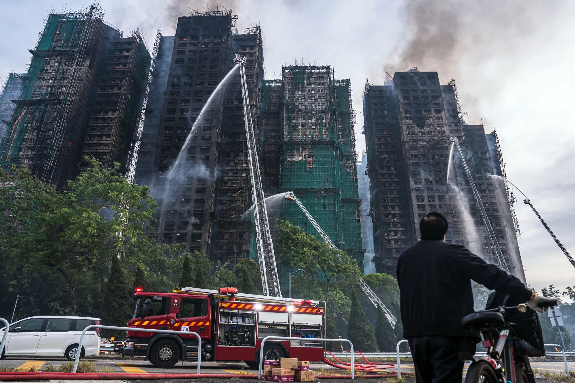 Smoke rises from residential buildings as fires continue to burn at Wang Fuk Court in Hong Kong on Nov. 27.