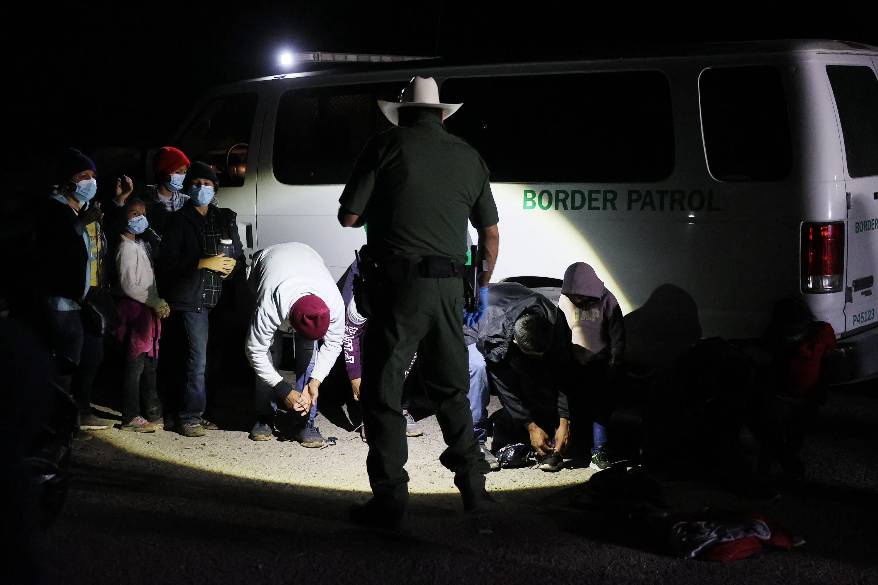 U.S. border patrol officers process migrants in Roma, Texas in March.