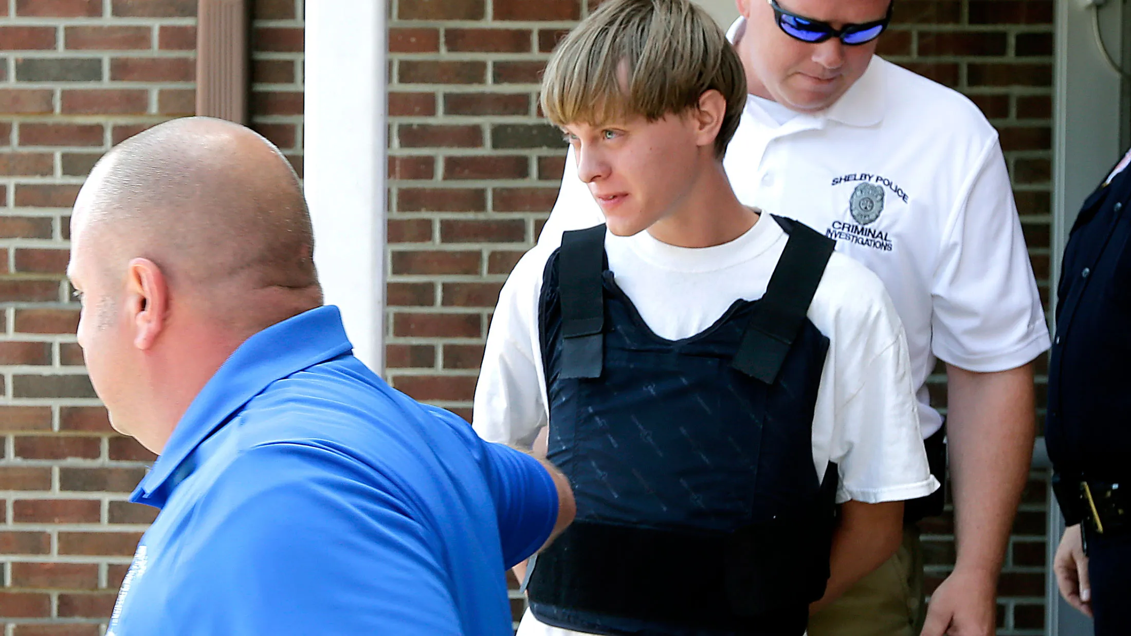 Charleston, S.C., shooting suspect Dylann Storm Roof, center, is escorted from the Shelby Police Department in Shelby, North Carolina, on June 18, 2015.
