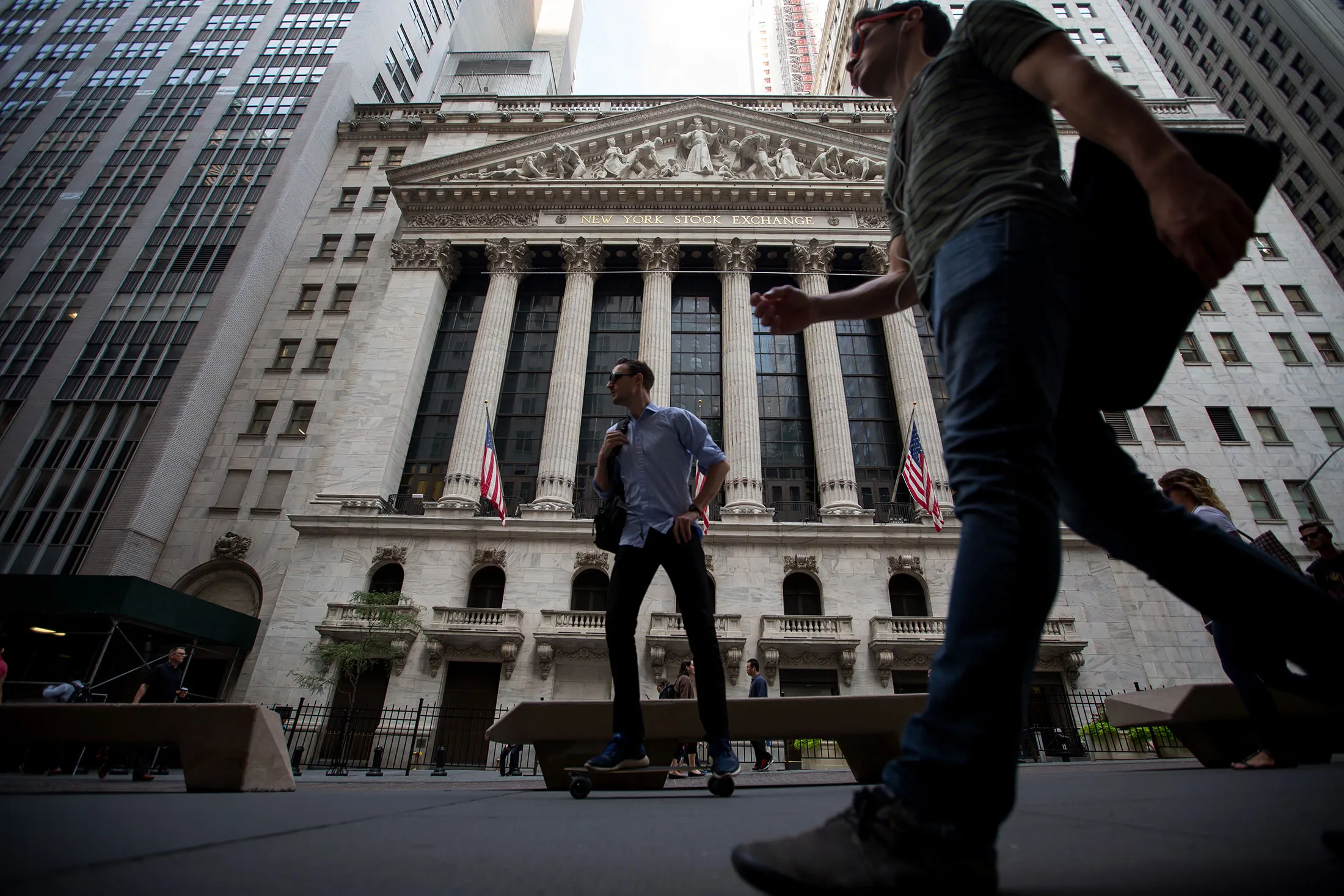 Pedestrians pass the New York Stock Exchange (NYSE) in New York, U.S., on Friday, Aug. 26, 2016. U.S. stocks rose as investors focused on Federal Reserve Chair Janet Yellen's bullish comments on the economy and signaled more skepticism that Federal Reserve officials will follow through with interest-rate increases.
