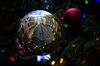 The New York Stock Exchange (NYSE) is reflected in a Christmas tree ornament in New York, U.S..