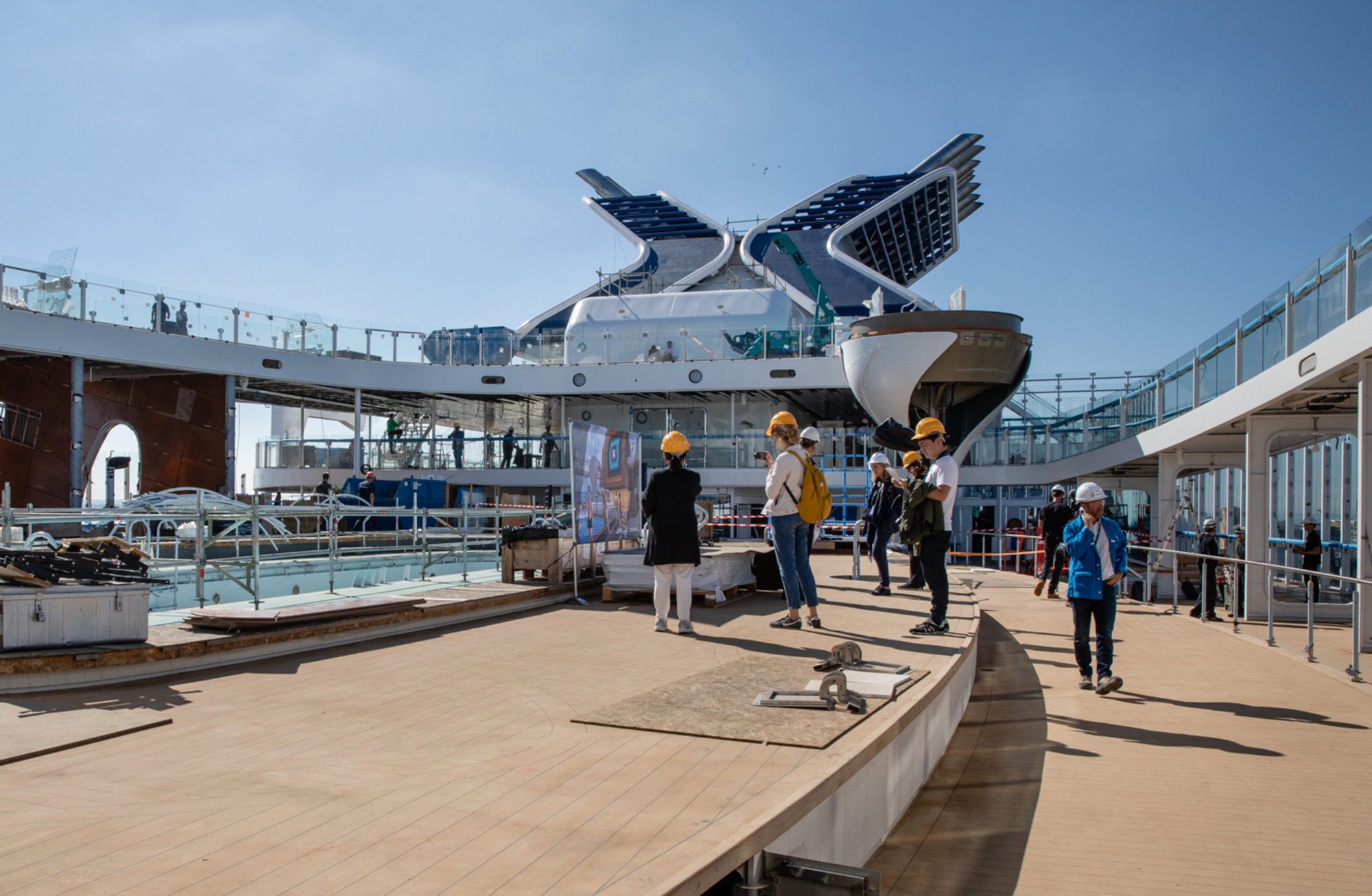 Visitors inspect the Resort deck area as construction work continues aboard the Celebrity Edge cruise ship, operated by Royal Caribbean Cruises.