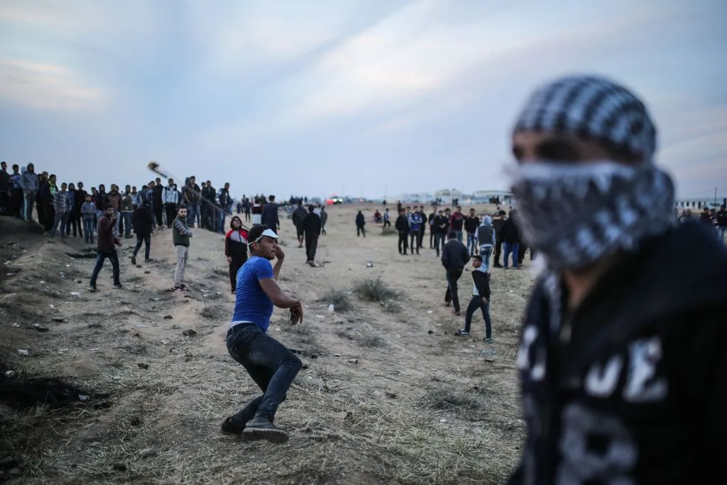 A Palestinian protester flings a rock toward Israeli defense forces on April 2.
