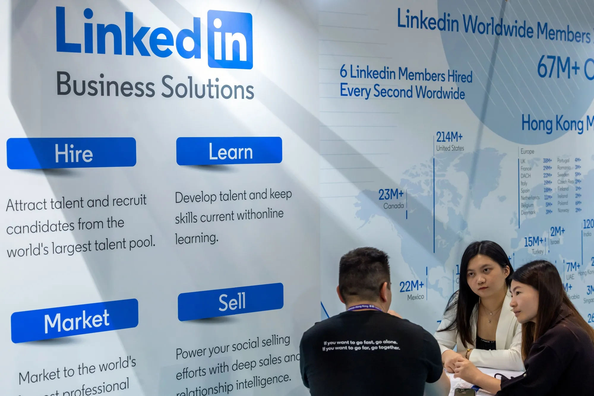 Attendees at a LinkedIn booth during a career fair.