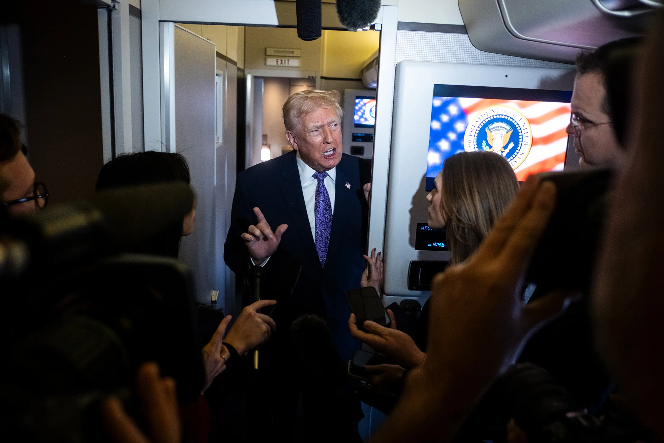 President Donald Trump speaks to reporters aboard Air Force One en-route to Washington, DC, on Nov.&nbsp;30.