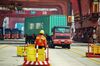 A staff member watches a truck carrying a container at a port in Qingdao in China's eastern Shandong province on April 17, 2019. - China's economy beat forecasts as it remained steady with 6.4 percent growth in the first quarter amid tepid global demand, a US trade war and a debt battle, official data showed on April 17. (Photo by STR / AFP) / China OUT (Photo credit should read STR/AFP/Getty Images)