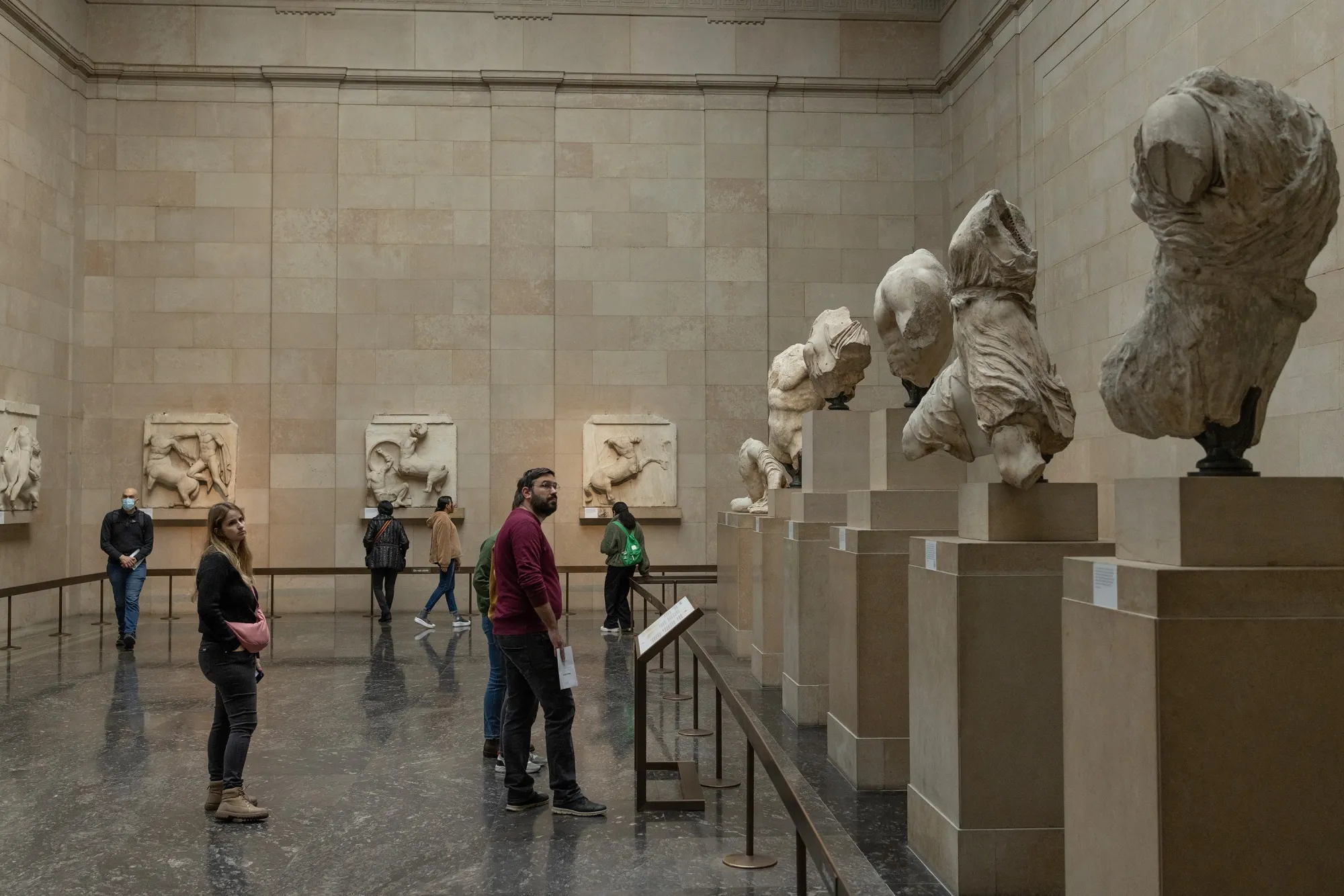 Visitors view the Parthenon marbles at the British Museum in London.