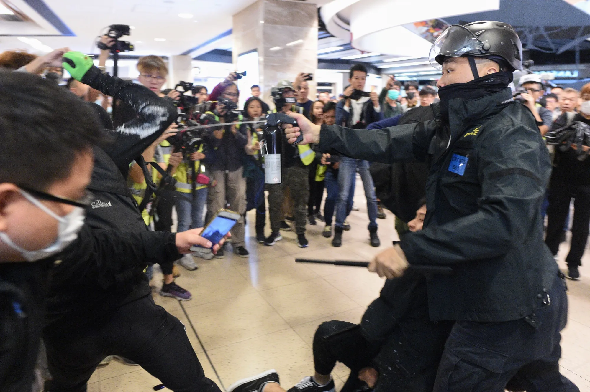 Police deploy pepper spray during a protest at the New Town Plaza shopping mall in Shatin on Dec. 15.