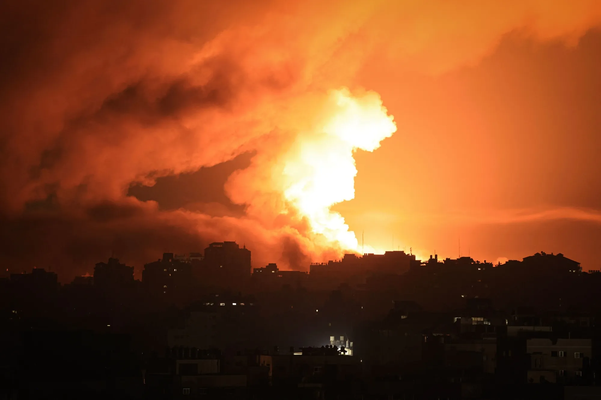 Fire and smoke rise above buildings in Gaza City during an Israeli air strike on Oct. 13.