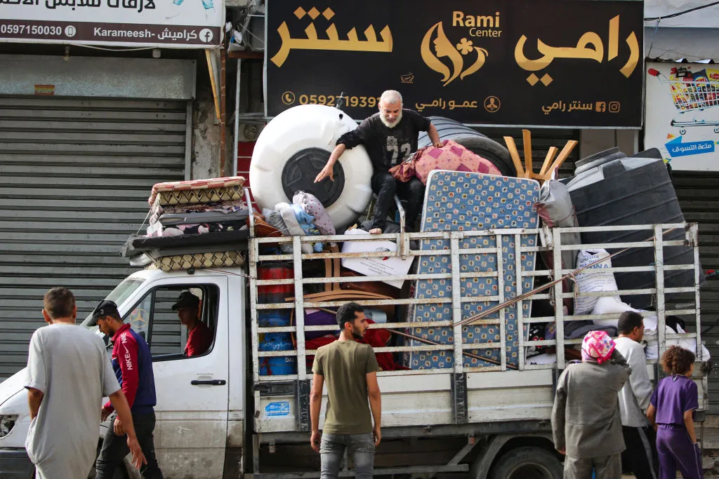 Palestinians load their belongings on the back of a truck as they flee Rafah &nbsp;to a safer location, on May 11.