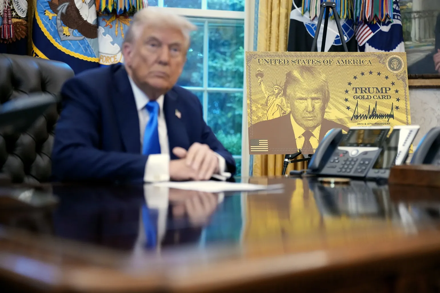 President Donald Trump delivers remarks alongside a poster of the "Trump Gold Card" before signing an executive order at the White House in Washington on Sept. 19.&nbsp;
