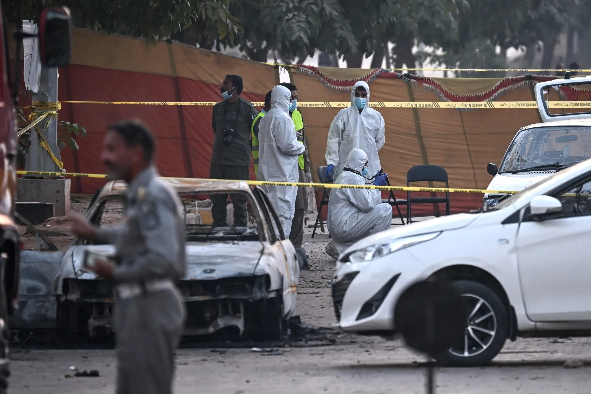 Forenstics officers at the site of a car bomb explosion outside a district court in Islamabad, on Nov. 11.