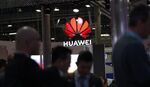 An illuminated logo hangs above the Huawei Technologies Co. pavilion on the opening day of the MWC Barcelona in Barcelona.