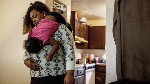 Jessica Johnson-Peterson carries her daughter.