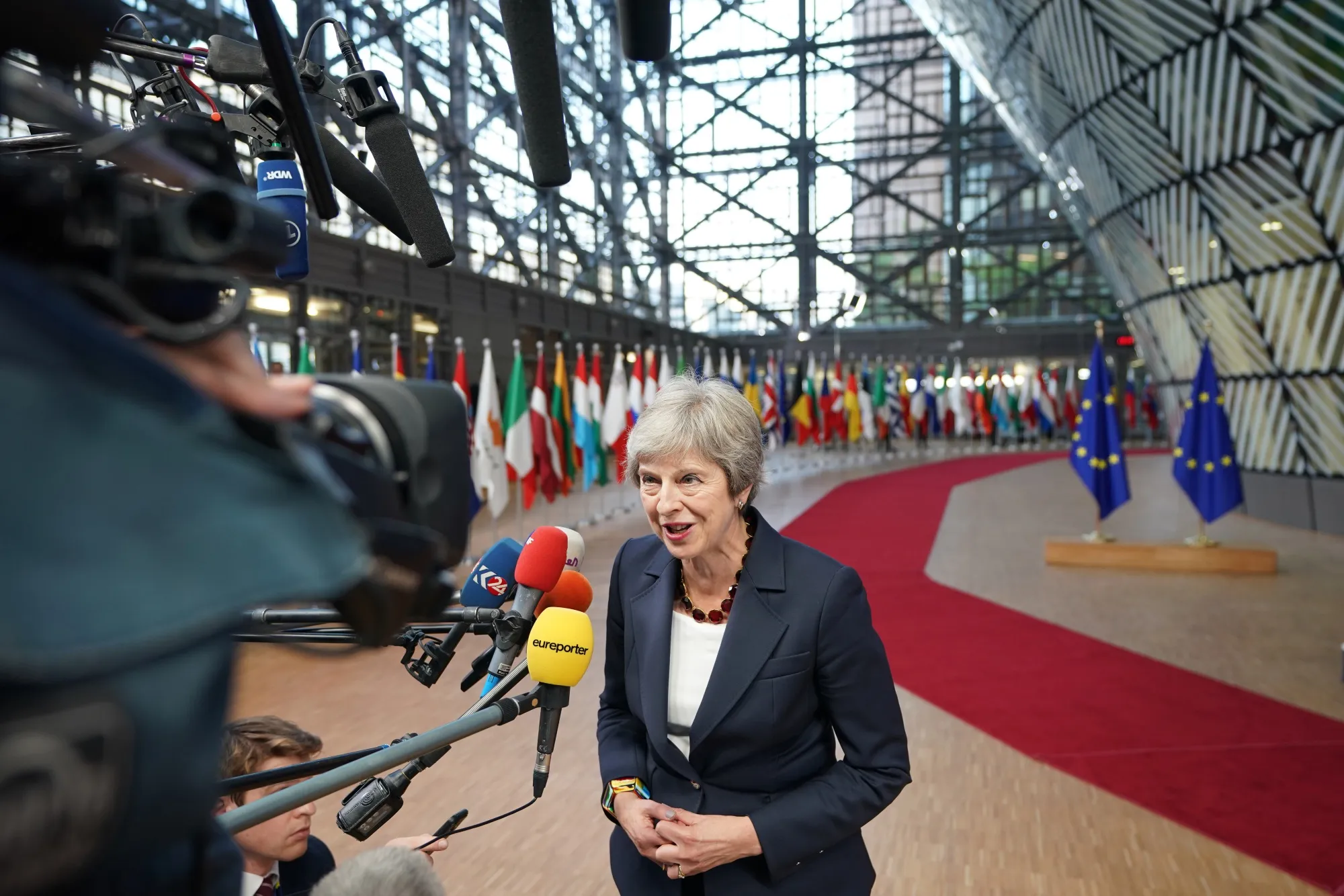 Theresa May speaks to reporters as she arrives ahead of a European Union leaders Brexit summit in Brussels on Oct. 17, 2018.