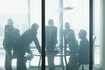 Silhouette of business people leaning on table in conference room