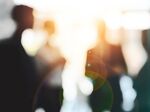 Defocused shot of a group of businesspeople having a discussion in an office
