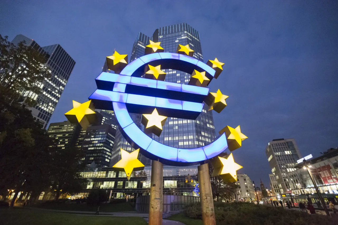 A euro sign sculpture stands illuminated in front of the European Central Bank (ECB) headquarters in Frankfurt, Germany.