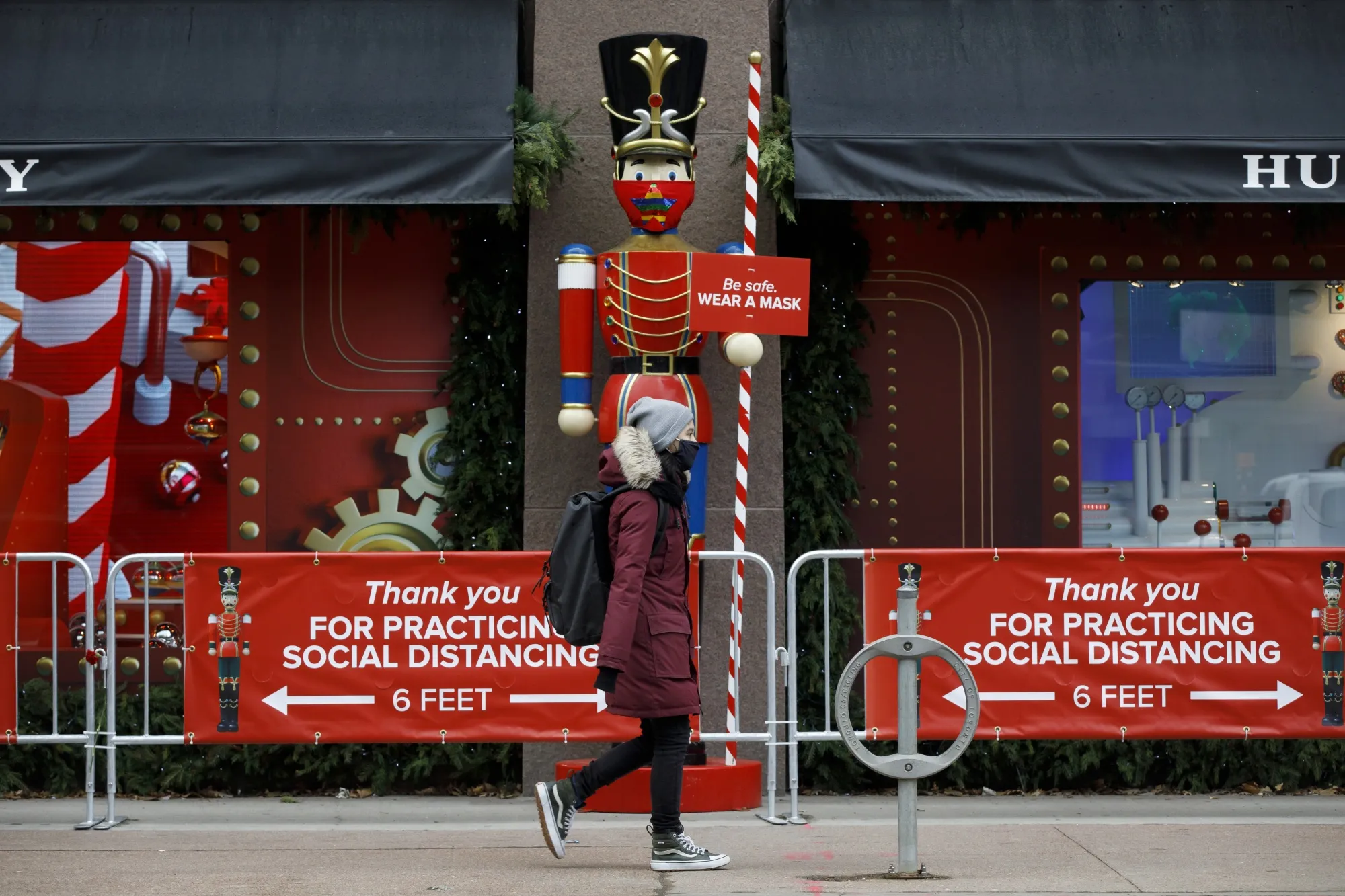 A pedestrian walks past a holiday display at a Toronto department store on Nov. 23, after the start of a fresh lockdown in Canada’s financial capital and one of its suburbs.