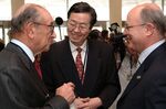 Alan Greenspan, left, and Zhou Xiaochuan, center, talk with Malcolm Knight, then general manager of BIS, in 2003.