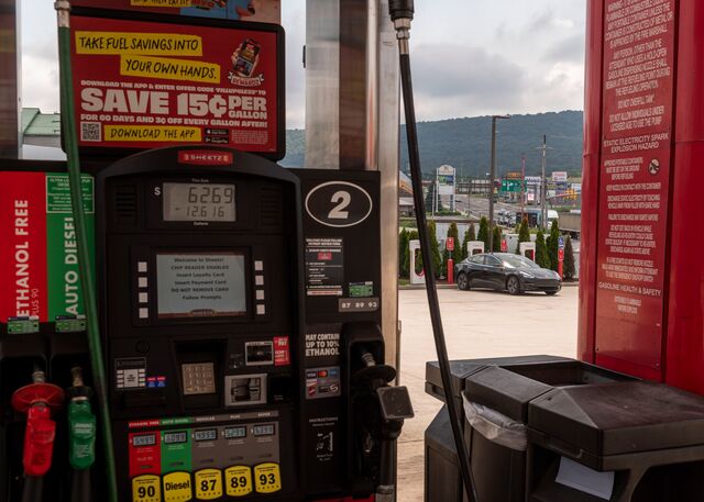 Sheetz gas station pump with Tesla branded electric vehicle charger seen in the background.