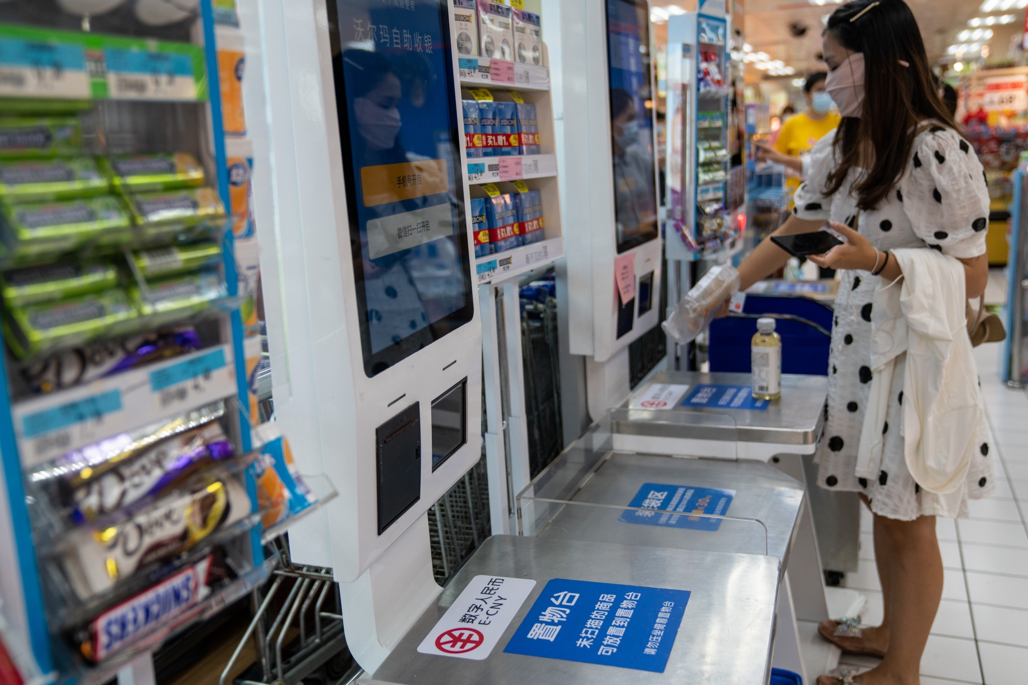 Signage for the digital yuan at a self check-out counter inside a supermarket in Shenzhen, China.&nbsp;