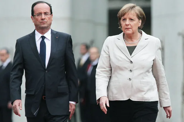 German Chancellor Angela Merkel welcomes French President Francois Hollande at the Chancellery in Berlin