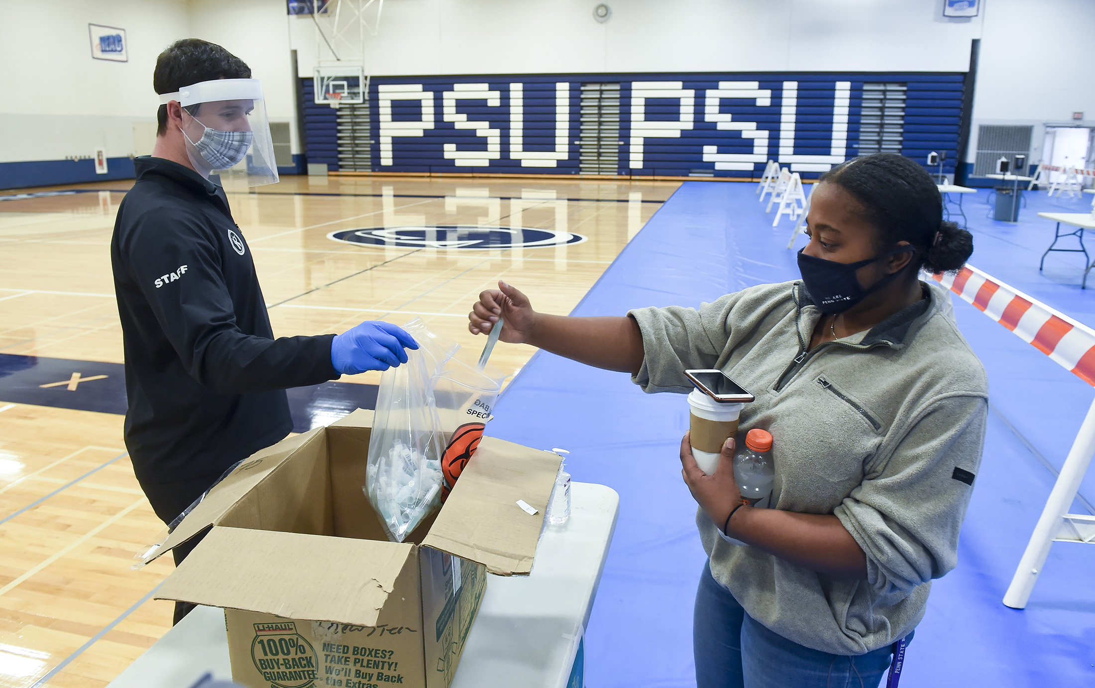 A Penn State University student places a Covid-19 departure test into a collection bag ahead of Thanksgiving holiday travel on Nov. 16.