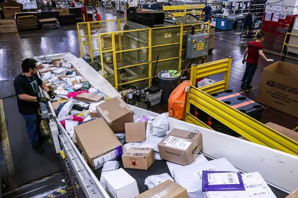 A worker sorts packages at a&nbsp;US&nbsp;Postal Service processing center in Dulles, Virginia.