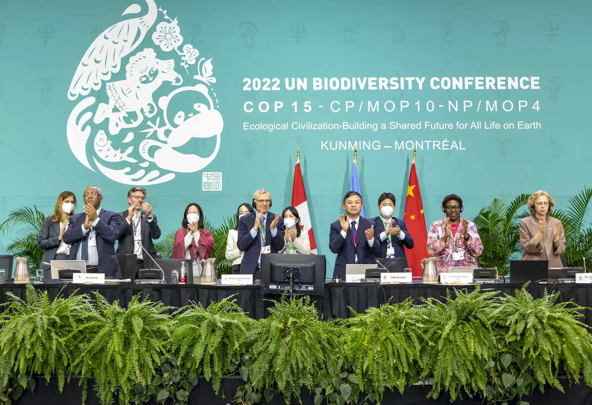 COP15 president Huang Runqiu, fourth right, applauds during the COP15 conference in Montreal, Canada, on Dec. 19.