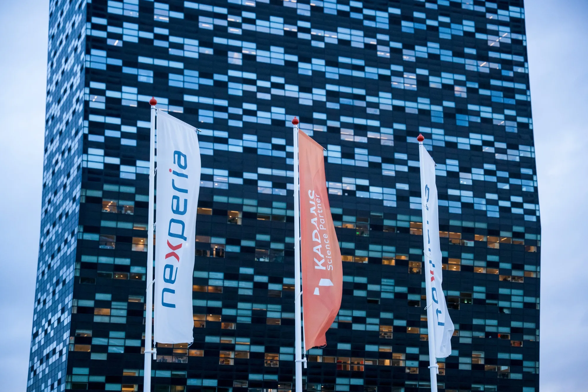 Flags with the Nexperia Holding BV logo outside their headquarters in Nijmegen, Netherlands.
